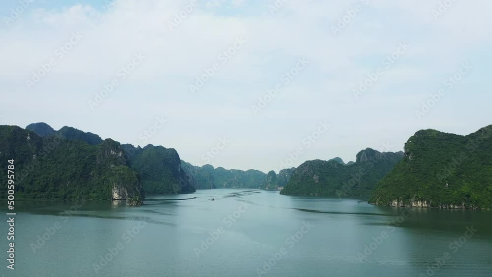 The green karst cliffs of Ha Long Bay , Asia, Northern Vietnam towards Hai Phong, Lanh Ha in summer on a sunny day. The green karst cliffs of Ha Long Bay , Asia, Northern Vietnam towards Hai Phong, Lanh Ha in summer on a sunny day.
