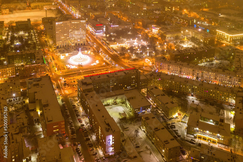 Fototapeta Naklejka Na Ścianę i Meble -  Aerial view of the town and Five Corners square with Christmas tree on polar night. Murmansk, Russia.