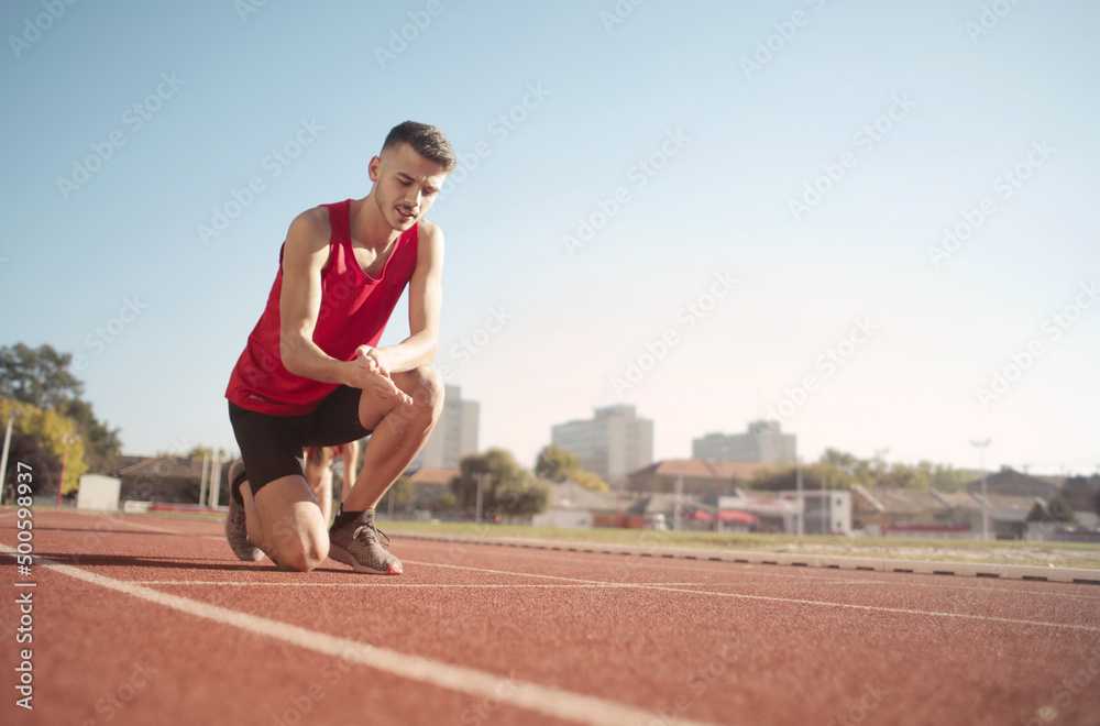 young man on the track ready to go