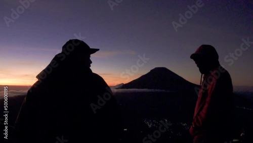 The natural beauty of the peak of Sikunir from the Dieng Plateau at sunrise, Mount Sindoro is clearly visible and the surrounding hills are truly stunning. photo