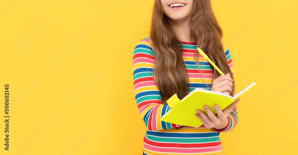 Happy school kid learn to write with eyes closed yellow background, homework Happy school kid learn to write with eyes closed yellow background, homework