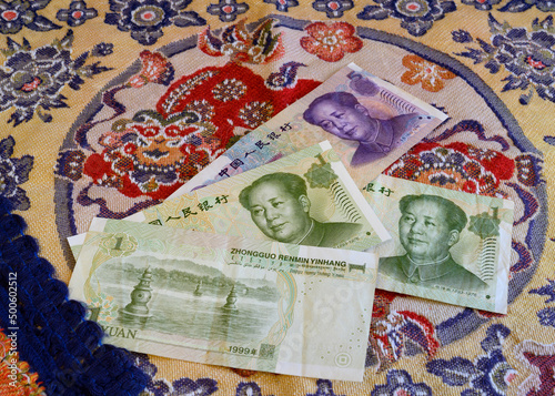 Chinese yuan banknotes on the background of national embroidery photo