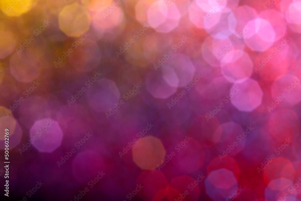 Blur sparkles. Defocused pink yellow purple color gradient shiny grain texture on dark background. Bokeh glow lights for backgrounds, compositions and overlays.