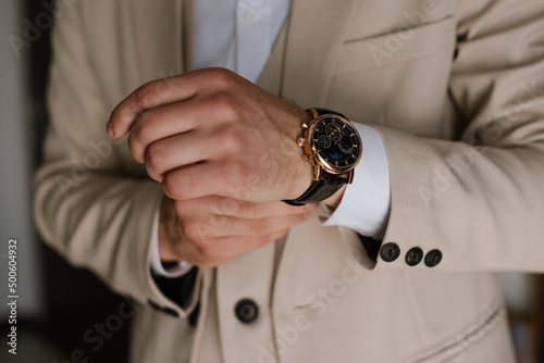 Groom wearing a watch on his arm. Close up