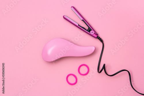  Сomposition with professional hairdresser tools on pink background. Flatlay.
