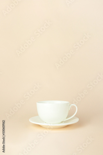 Porcelain cup flying with on beige background. Gravity , levitation concept. Free space for text.