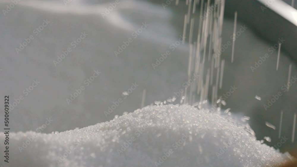 Falling polypropylene granules, slow motion. Polypropylene granules. Polypropylene granules close-up. Nonwoven Fabric Factory