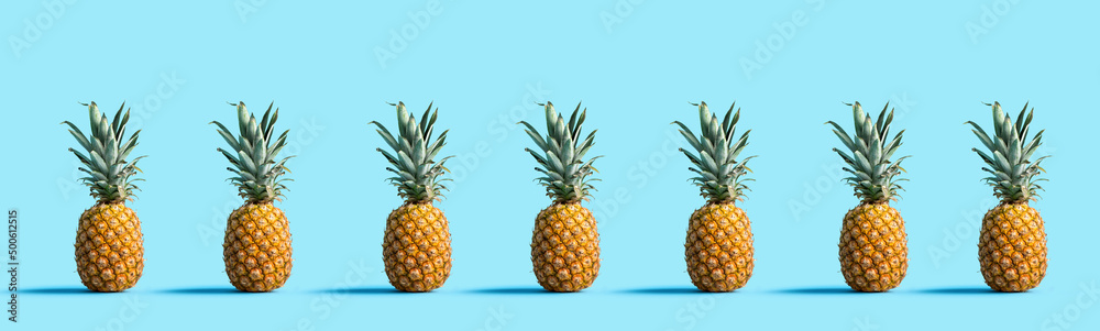 Many pineapples on a solid color background Many pineapples on a solid color background
