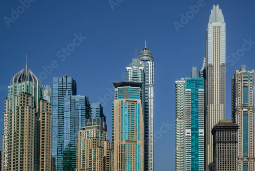 Futuristic skyscrapers of Dubai Marina against the blue sky © Blazenka