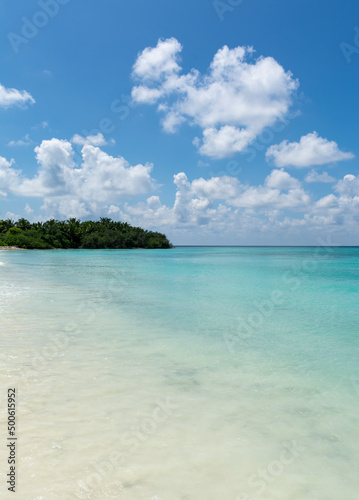 Blue sky with awesome clouds  turquoise ocean water with clear sand view from Maldives Beach