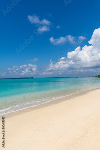 Beautiful background image of tropical beach, Blue sky with awesome clouds, turquoise ocean with clear sand, photo taken from Maldives beach