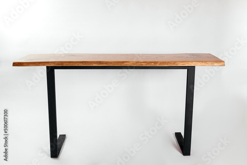 Handmade wooden table on metal racks on a white background