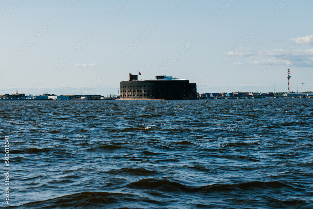 View from a boat on Fort Alexander the First in Kronstadt in the waters of the Gulf of Finland. Island of forts. Summer day