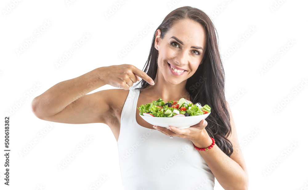A good looking woman pointing her finger at a lettuce leaf with ingredients for a healthy diet A good looking woman pointing her finger at a lettuce leaf with ingredients for a healthy diet