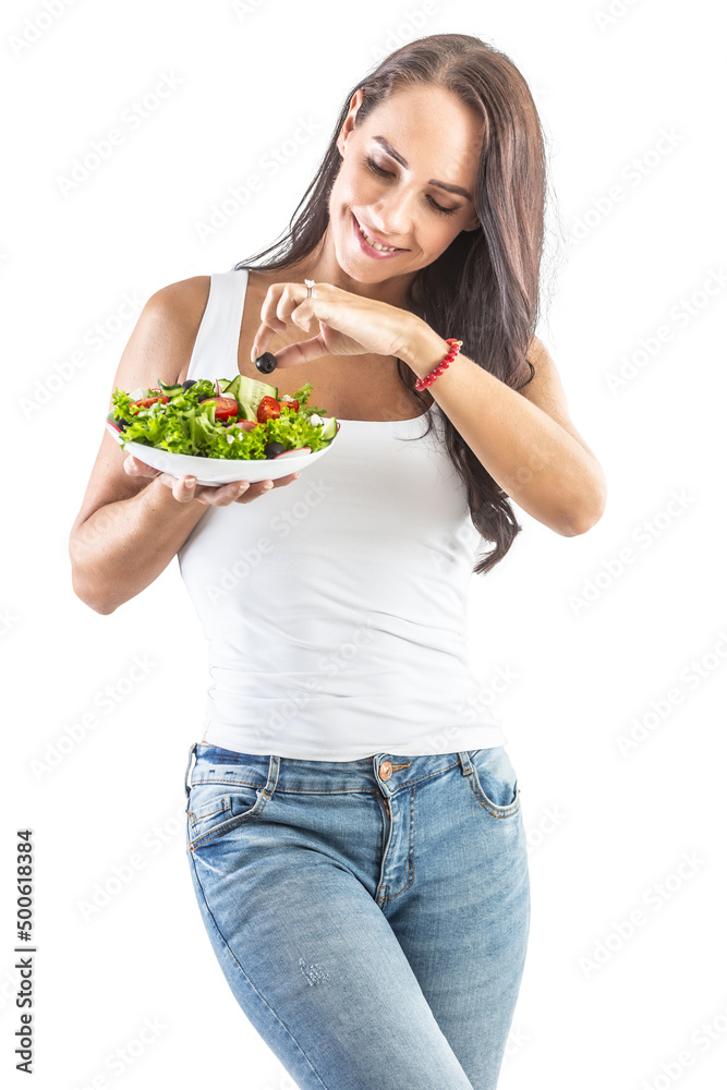 A good looking woman holding a bowl of fresh salad, tasting a black olive A good looking woman holding a bowl of fresh salad, tasting a black olive
