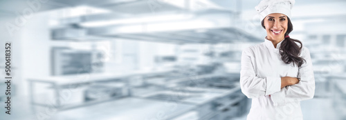 Portrait of young chef in restaurant kitchen.