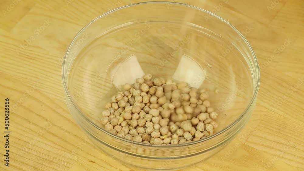 Strewed chickpeas in a bowl filled with water Strewed chickpeas in a bowl filled with water