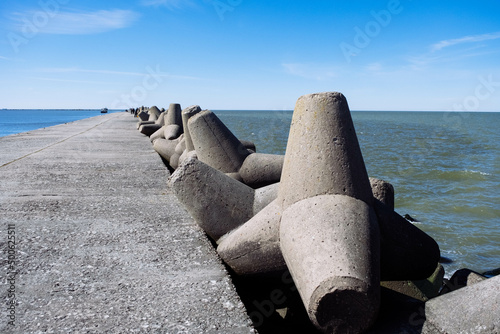 Bild auf Leinwand The Northern Breakwater in Liepaja, a close-up of tetrapods and splashing, splattering waves