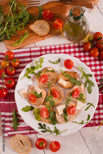 Friselle with cherry tomatoes and arugula.