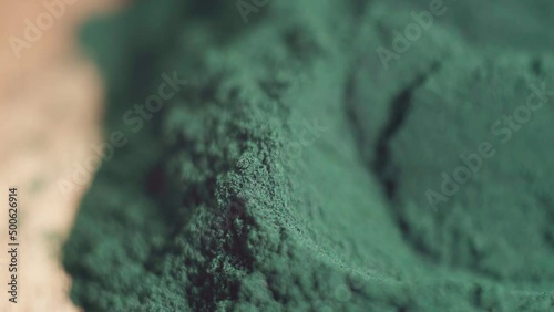 Spirulina algae powder close up. Superfood concept. Macro photography. Selective focus