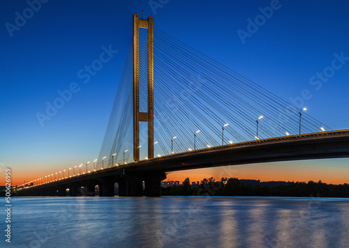 Fototapeta Naklejka Na Ścianę i Meble -  Cable-stayed bridge South in the city of Kyiv. The highest bridge in Ukraine, the height of the pylon is 136 meters. Focus is in the center of the photo on the bridge pylon.