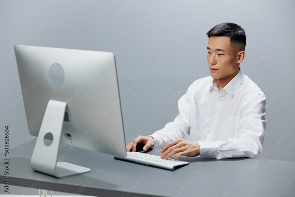 manager in front of the computer with headphones emotions Gray background