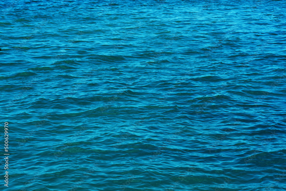 .small waves on the surface of the blue water