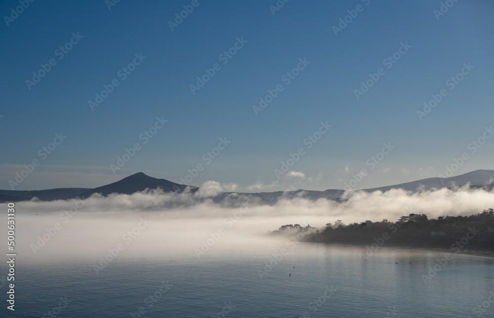 Foggy landscape view of Kiliney Bay, Dublin and Sugarloaf Mountain in Wicklow, Ireland 