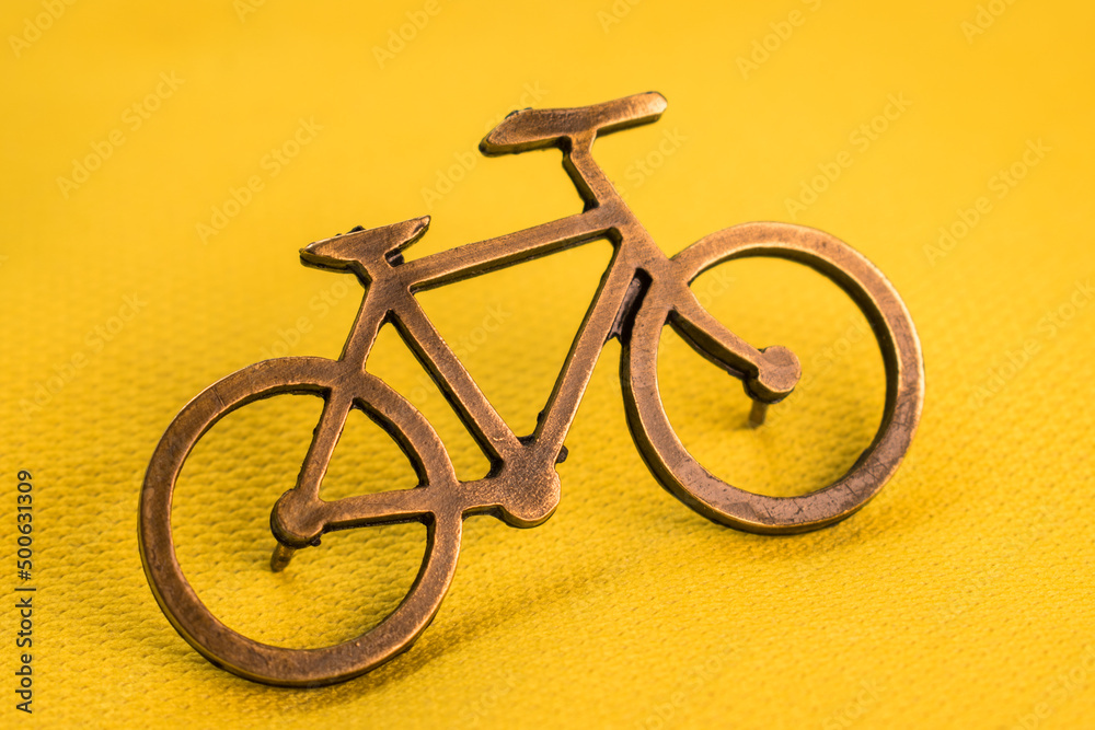 Golden bike pin on yellow tour de france t-shirt