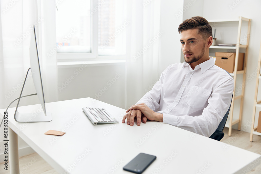 businessmen sitting at a desk in front of a computer with a keyboard workplace businessmen sitting at a desk in front of a computer with a keyboard workplace