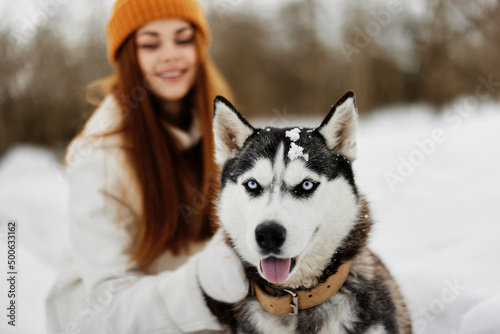 woman with dog on the snow walk play rest fresh air