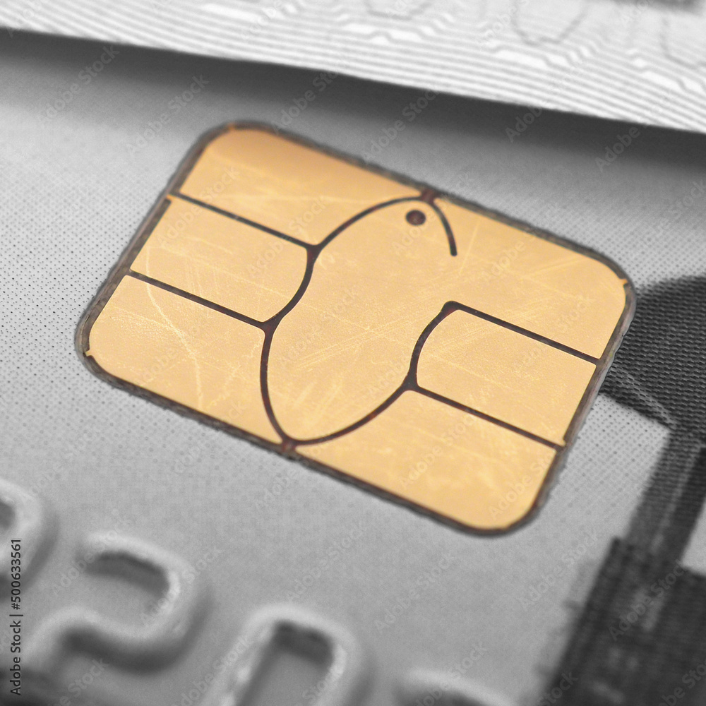 Fragments of a bank plastic card and banknote. Yellow integrated chip closeup. It is highlighted in color. The rest of the picture is black and white. Square illustration. Macro Fragments of a bank plastic card and banknote. Yellow integrated chip closeup. It is highlighted in color. The rest of the picture is black and white. Square illustration. Macro