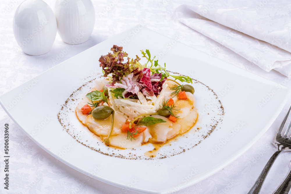 Salad with crab and scallop on a white plate Salad with crab and scallop on a white plate