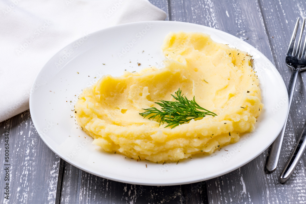 mashed potatoes on a white plate on grey wooden table mashed potatoes on a white plate on grey wooden table