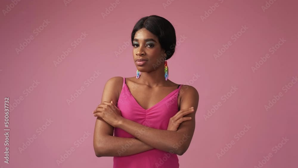 Exciting expectation. Evil plan. Coming soon. Confident curious smirking tricky woman waiting isolated on pink empty space advertising background.