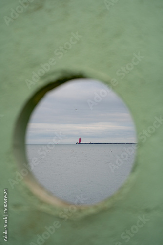 Photography Poolbeg lighthouse and pier in Dublin framed by green stone circle