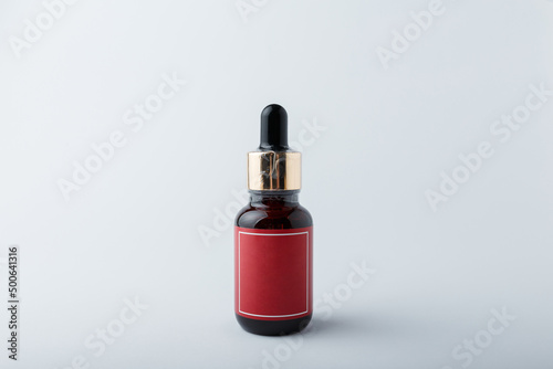 Face skin care cosmetics. Brown bottle of azelaic or hyalurone acid on white background. Mock up, no brand template, copy space