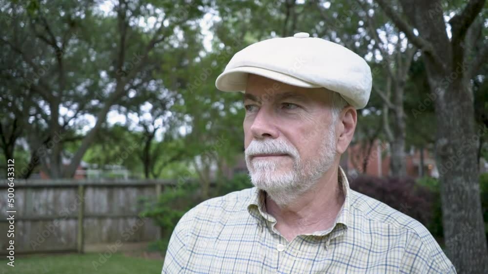 A senior man glad to be free from allergic reactions to pollen and other allergens contented to spend time outdoors enjoying his backyard. A senior man glad to be free from allergic reactions to pollen and other allergens contented to spend time outdoors enjoying his backyard.