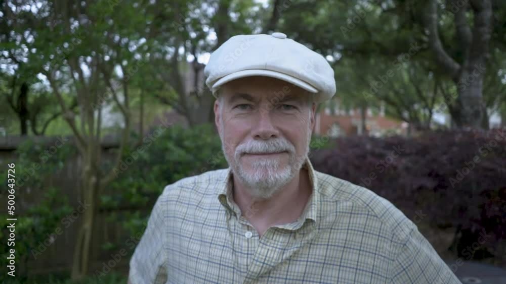 A senior man glad to be free from allergic reactions to pollen and other allergens standing outside in his backyard on a pretty spring day. A senior man glad to be free from allergic reactions to pollen and other allergens standing outside in his backyard on a pretty spring day.