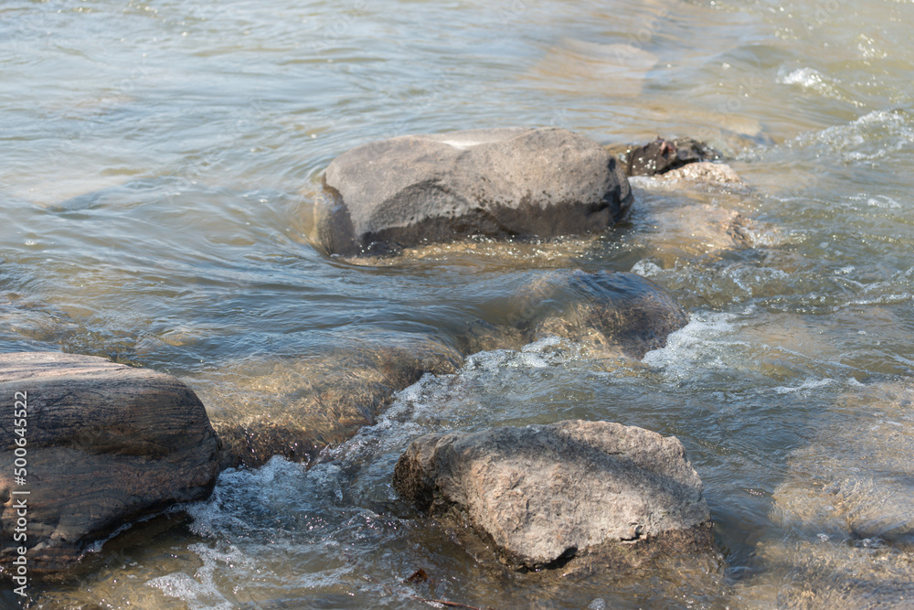 water flowing around rocks in the river