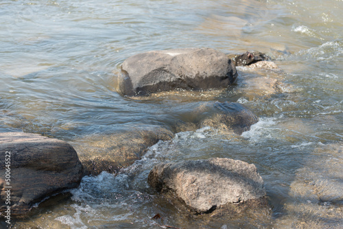 water flowing around rocks in the river