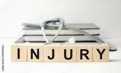 injury word on the wooden cubes and stethoscope