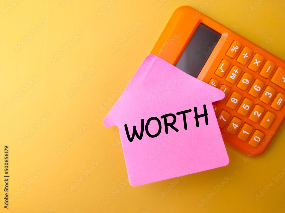 Business concept. Calculator and sticky note with the word WORTH Business concept. Calculator and sticky note with the word WORTH