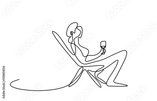 Woman sitting in relax comfortable chair with drinking glass in hand. woman sitting on sun lounger and drinking on vacation