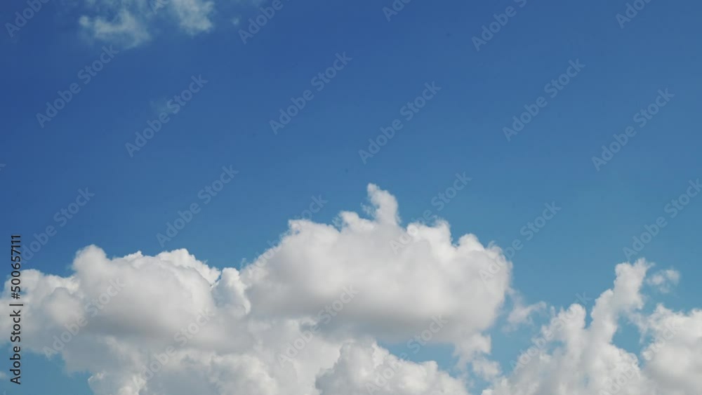 Sky cloud cotton blue clouds beautiful background outdoor moving cloud cluster swirling upward time-lapse . Cloud moving and transforming fast in the clear blue sky . Time lapse cloud beautiful sky Sky cloud cotton blue clouds beautiful background outdoor moving cloud cluster swirling upward time-lapse . Cloud moving and transforming fast in the clear blue sky . Time lapse cloud beautiful sky