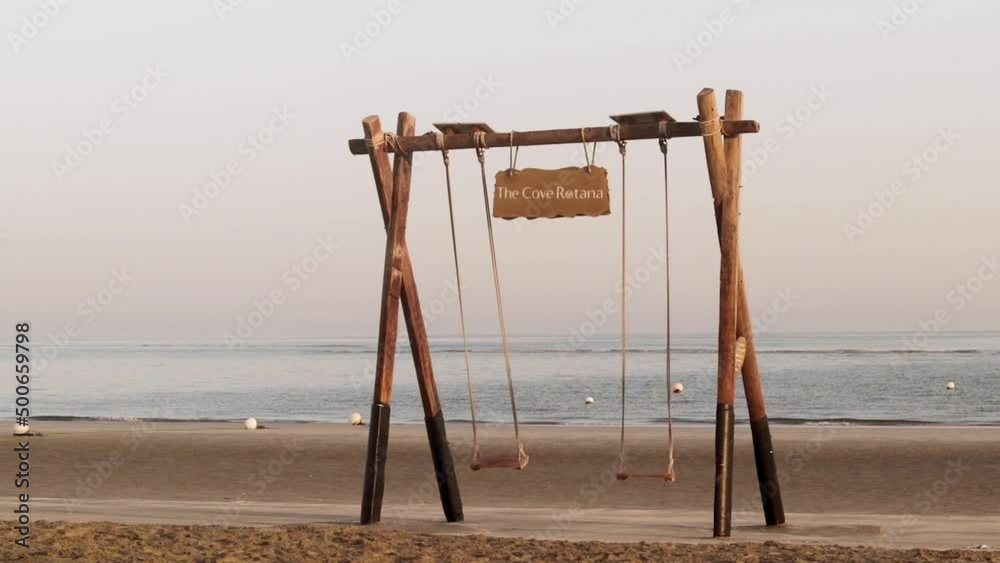 Ras Al Khaimah, UAE - 04.04.2022 - Swing by the beach at at The Cove Rotana Resort. Slow motion. Holiday Ras Al Khaimah, UAE - 04.04.2022 - Swing by the beach at at The Cove Rotana Resort. Slow motion. Holiday