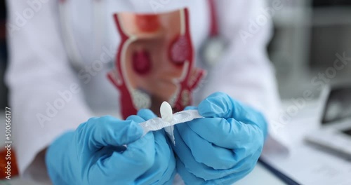 Doctor opens anal medical suppositories for digestive problems photo