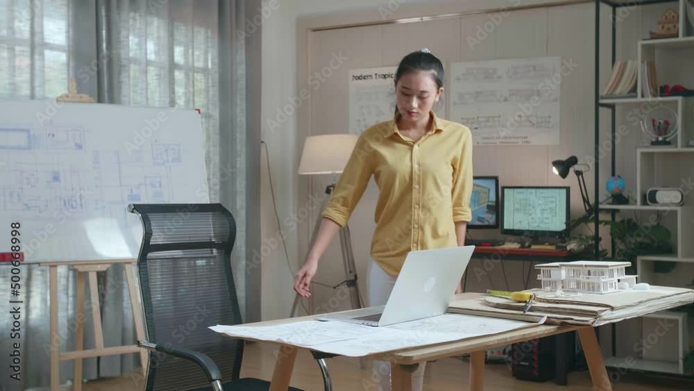 Asian Woman Engineer Walk Into The Office Before Looking At Blueprint And Typing On A Laptop
Asian Woman Engineer Walk Into The Office Before Looking At Blueprint And Typing On A Laptop