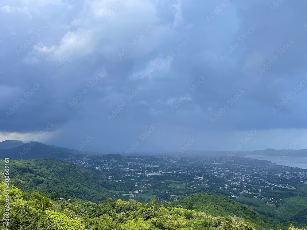 Perfect landscape. Panorama, seascape, view from above. Thunderstorms coming, beautiful thundercloud on the sky. Sea, green forest, town at the valley. Summer storm. Rainy weather. Spring and rain.