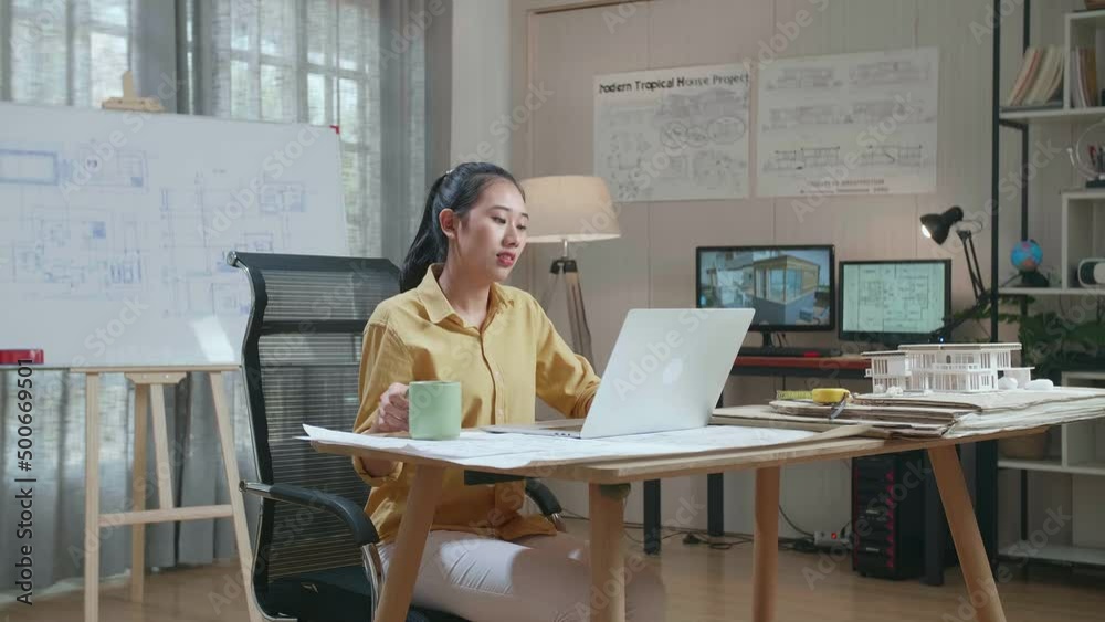Asian Woman Engineer Drinking Coffee While Using A Laptop To Work At The Office
Asian Woman Engineer Drinking Coffee While Using A Laptop To Work At The Office